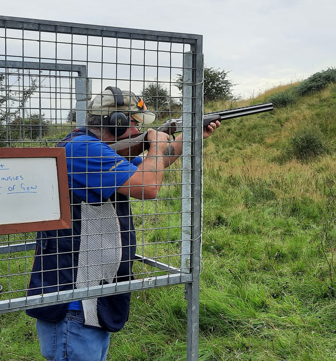 Tennis equipment including a racket, balls, and shoes on a clay court.